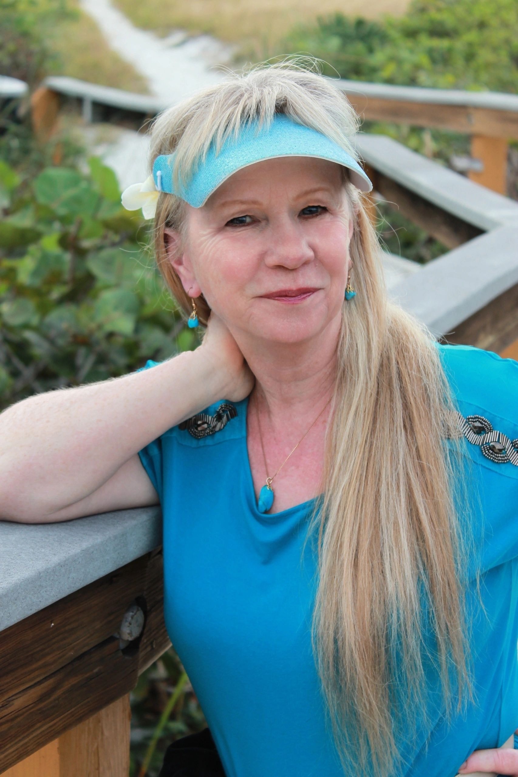 Vicki Reeve wearing a blue visor in a garden
